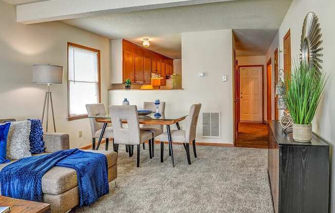 a living room and dining room with a table and chairs