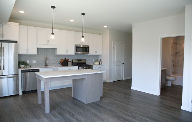 a kitchen and dining area in a 555 waverly unit