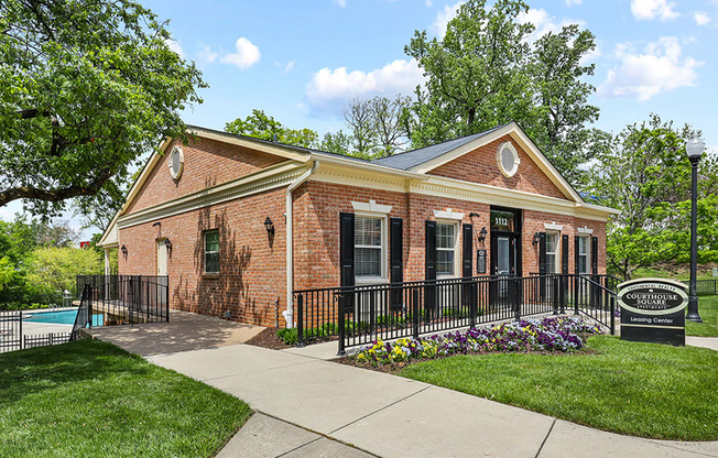 a brick building with a pool in the background