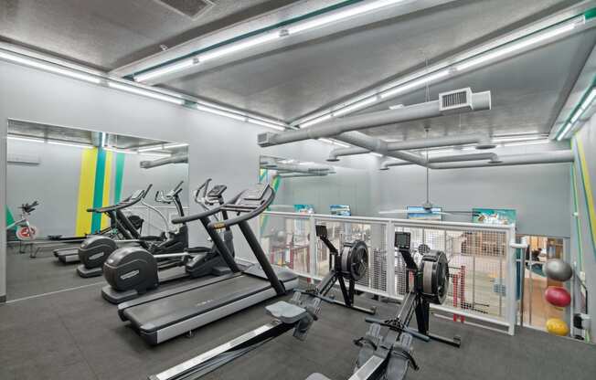 a gym with treadmills and other exercise equipment