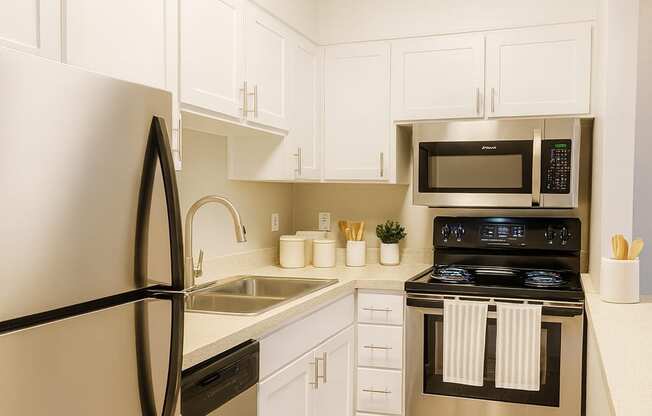 A kitchen with a black fridge and stove.