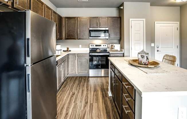 Kitchen with stainless steel appliances at Sterling Prairie Trail in Ankeny, IA