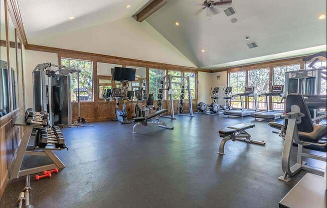 A spacious home gym with a variety of exercise equipment at Riverplace Apartment Homes, Oregon