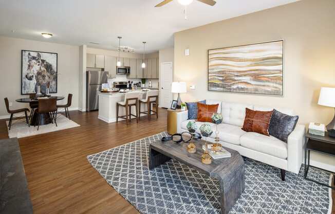 Madison, AL furnished living room with a sofa, two nightstands and wood-designed flooring at The Alexandria