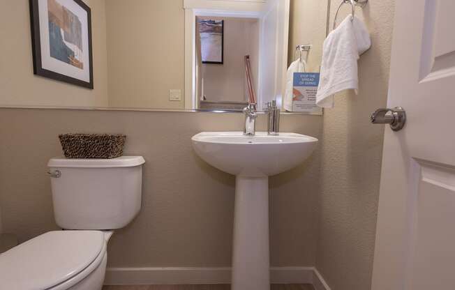 bathroom with a toilet sink and mirror