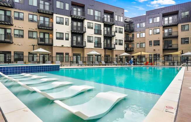 Apartments for Rent in Wheat Ridge - Parallel - Resort-Style Pool with In-Water Loungers, Deskside Lounge Chairs, and Spa