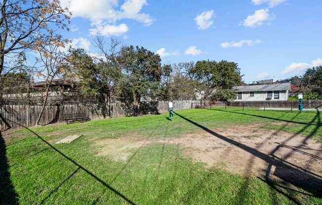 the backyard of a house with a yard and a fence