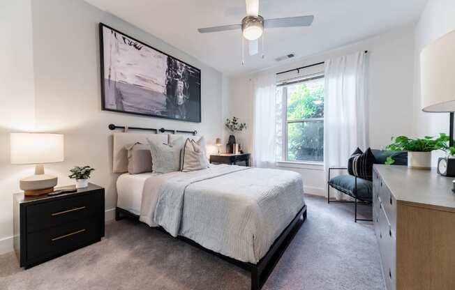a bedroom with a large bed and a ceiling fan