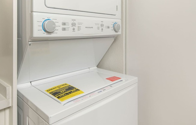 A white dishwasher with a control panel on top.