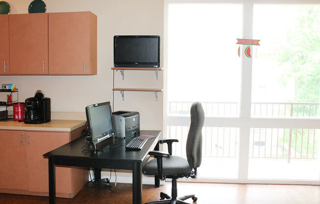 a room with a desk and a television