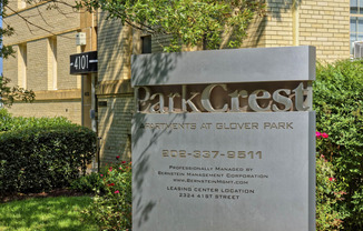 a sign in front of a building with flowers