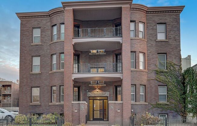 a large brick building with a balcony on top of it