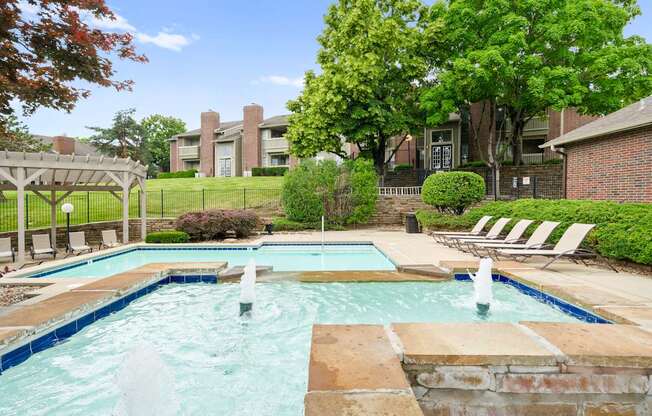 A pool with a waterfall in the middle of it.