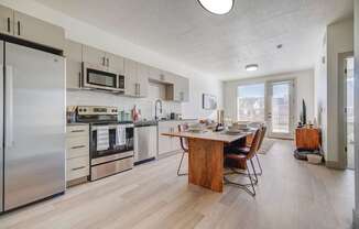 A modern kitchen with a dining table and chairs.