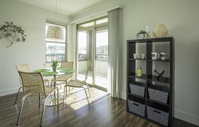 a dining room with a table and chairs and a window