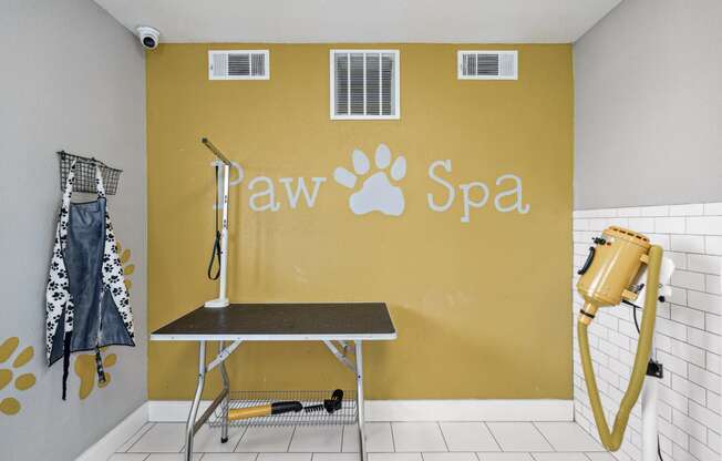 a spa with a table and a yellow wall with paw spa written on it