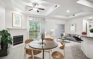 a living room with a table and chairs and a fireplace