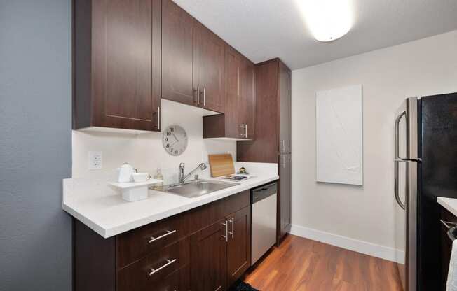 Kitchen with stainless steel appliances and white quartz counters