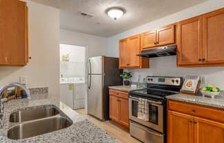 a kitchen with granite counter tops and stainless steel appliances