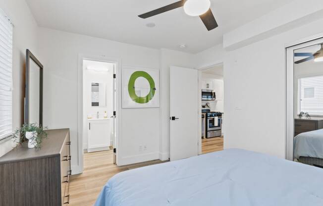 a bedroom with a large bed and a ceiling fan