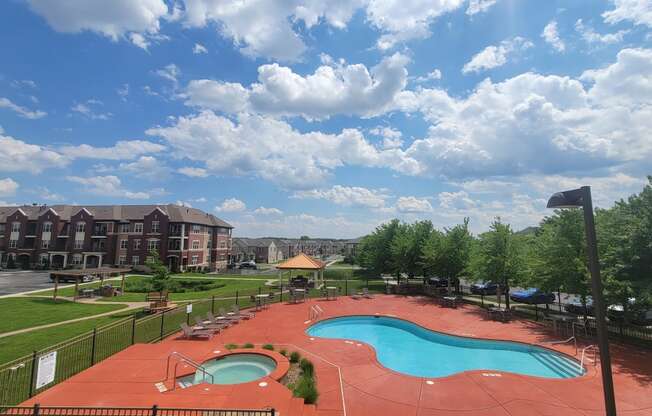 a view of a swimming pool and a resort with a building in the background