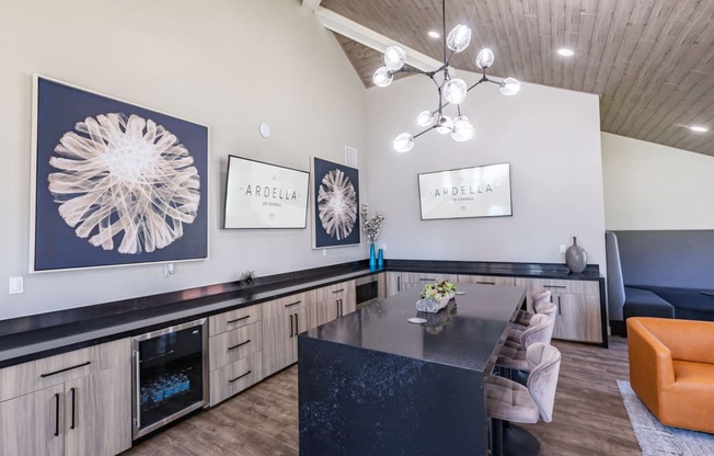 a kitchen with a black counter top and a dining table