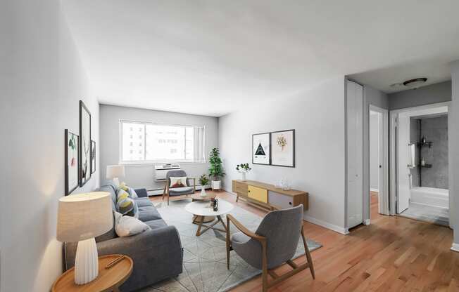 a living room with white walls and hardwood floors