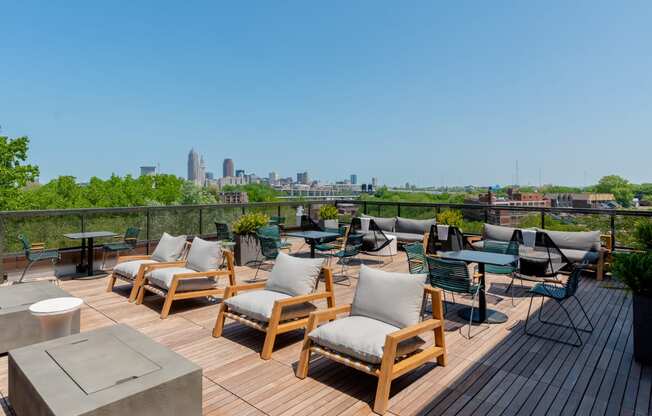 an outdoor deck with lounge chairs and a fire pit with a view of Cleveland TREO Apartments, Cleveland