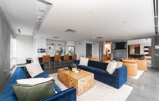 A living room with a blue couch and a coffee table.