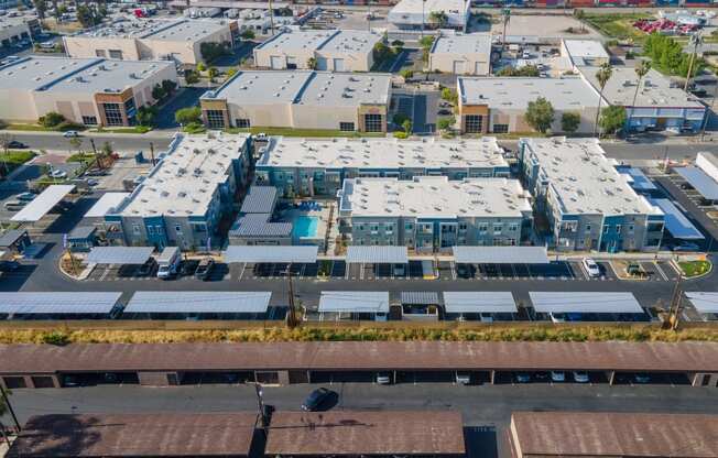 an aerial view of a group of houses with solar panels on their roofs at Loma Villas Apartments, California, 92408