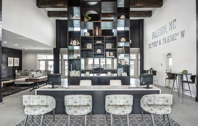 a lobby with a counter and chairs and a bar with stools