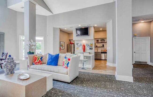 A living room with a white couch and a television.