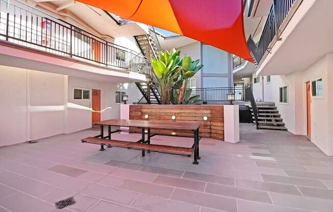 a courtyard with a wooden bench and a table