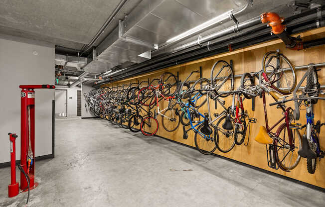 A bike rack with many bikes hanging on it.