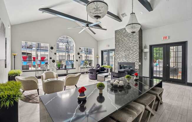 A modern dining room with a glass table and chairs.