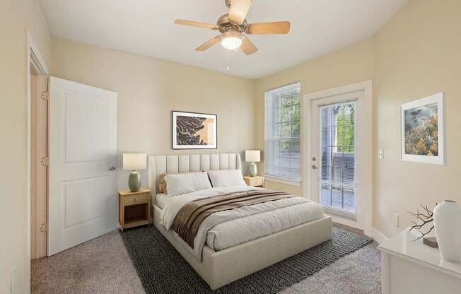 A bedroom with a large bed and a ceiling fan.