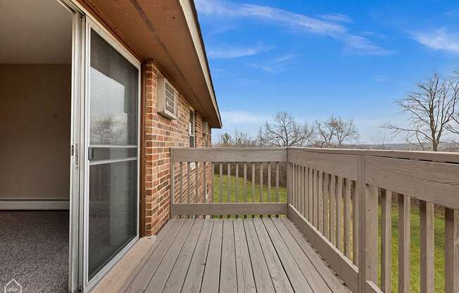 the deck of a home with a sliding glass door