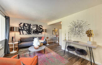 Living Room with Hardwood Inspired Floors, Orange Chairs and Window