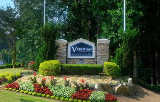 a garden with flowers and rocks in front of a yarddan sign