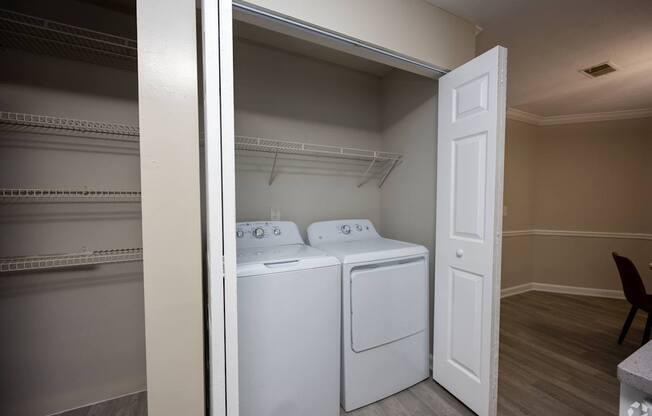 A laundry room with a washer and dryer in it.