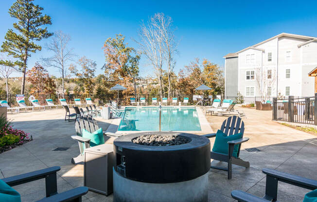 our apartments have a resort style pool and lounge area with chairs at Village at Westland Cove Apartments, Tennessee