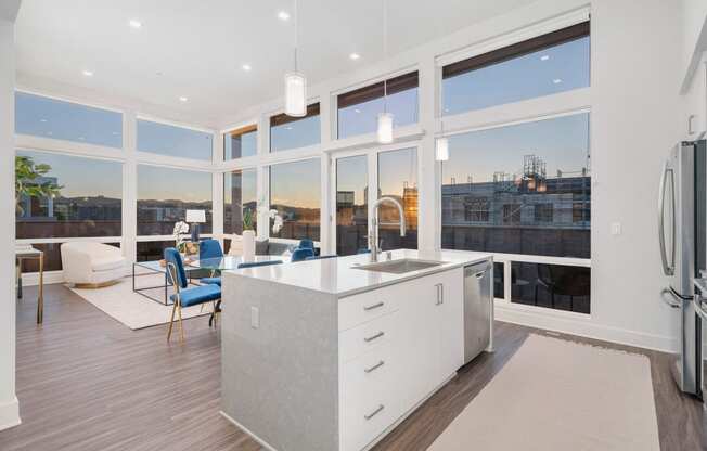 a white kitchen with a large group of windows