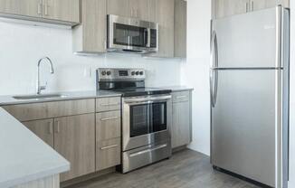 a kitchen with stainless steel appliances and wooden cabinets