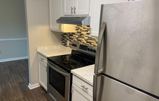 a stove top oven sitting inside of a kitchen