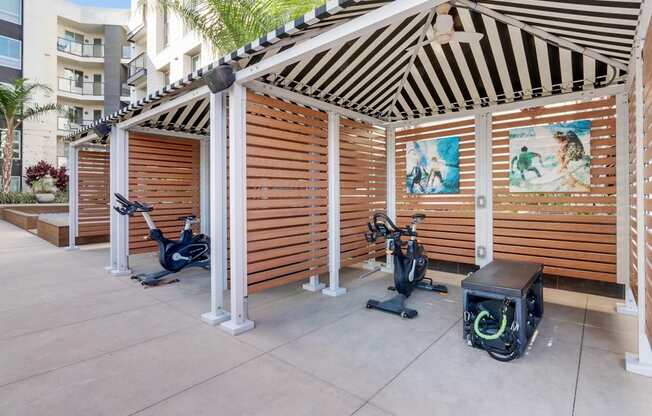 A wooden structure with exercise equipment inside.