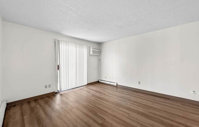 A room with wooden floors and a white door.