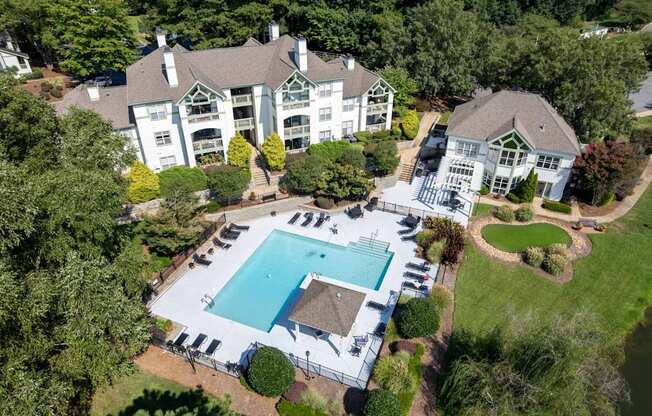 A large white house with a pool in the backyard.