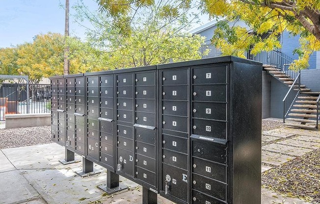 a group of mailboxes sitting on a sidewalk