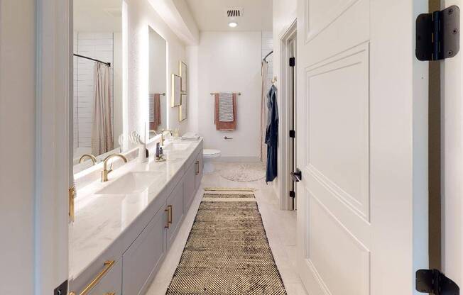 Luxe bathroom counters with backlit mirrors.  Double vanities in some homes*