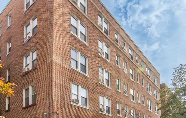 a large brick building with a sidewalk in front of it